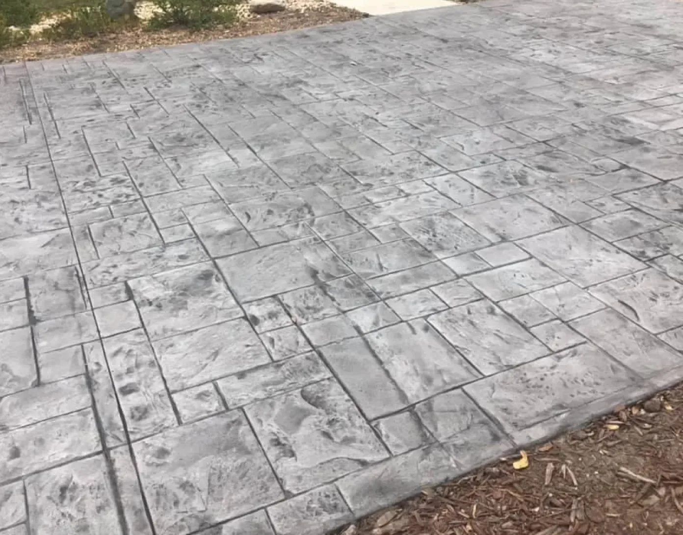 Gray ashlar slate stamped concrete driveway