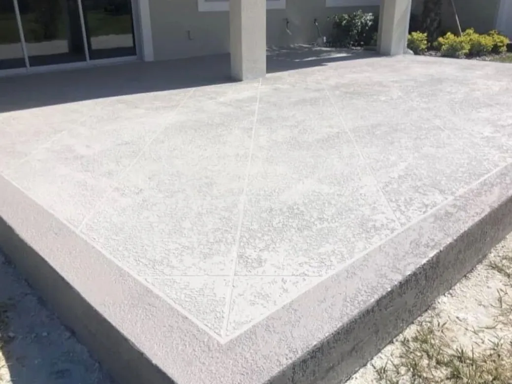 Gray spray texture finish with diamond score lines on a raised concrete patio in Brevard County