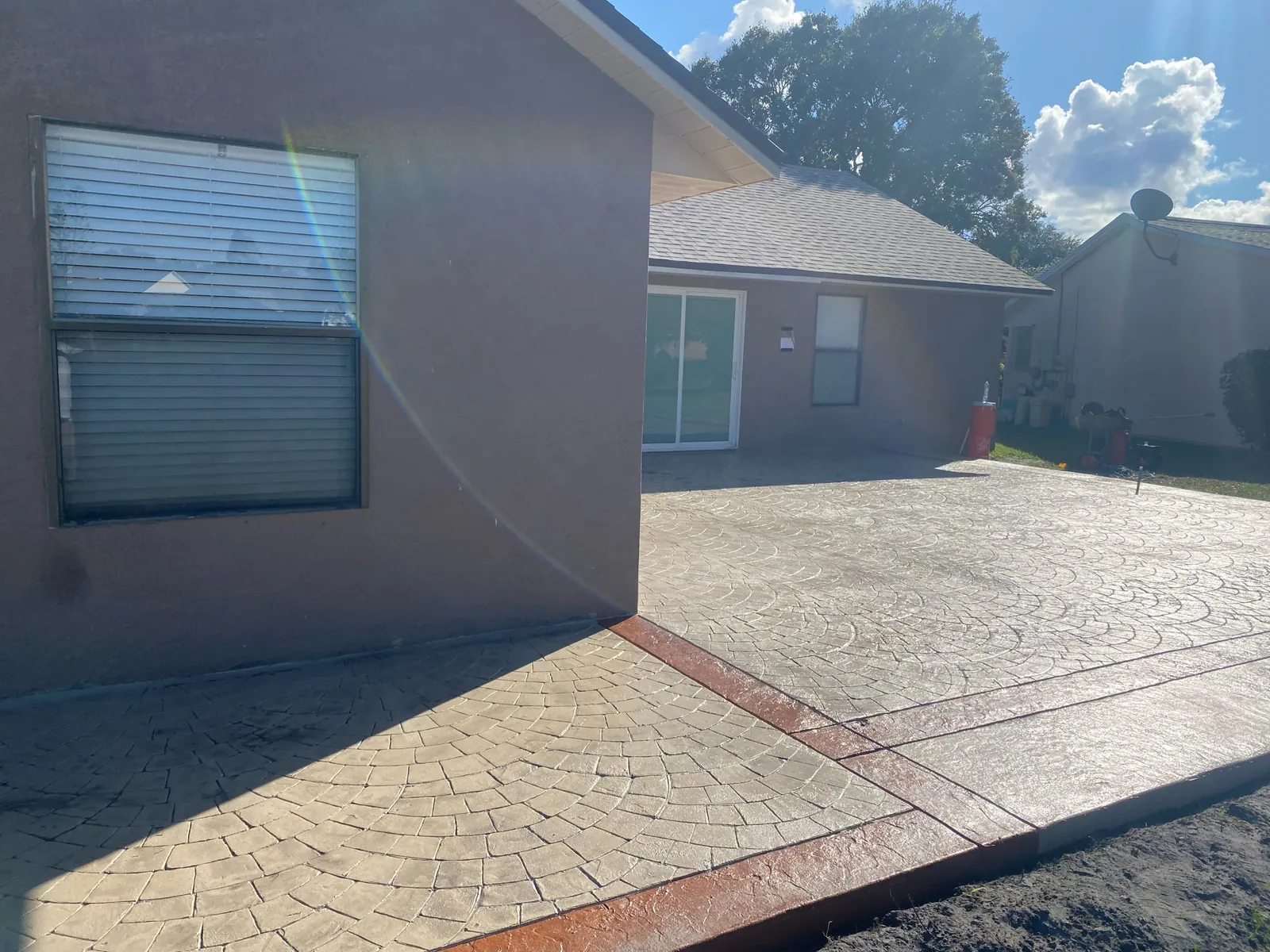 Stamped concrete patio with a red border band